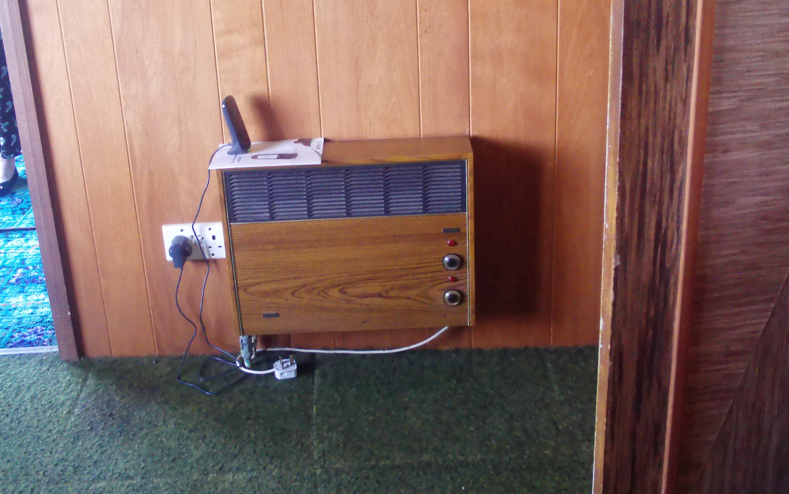 Old fan heater and decor in hallway